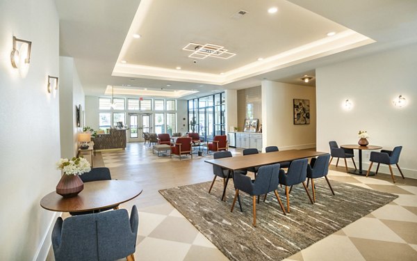 Clubhouse featuring modern design and ample seating at Jovie Pflugerville Apartments