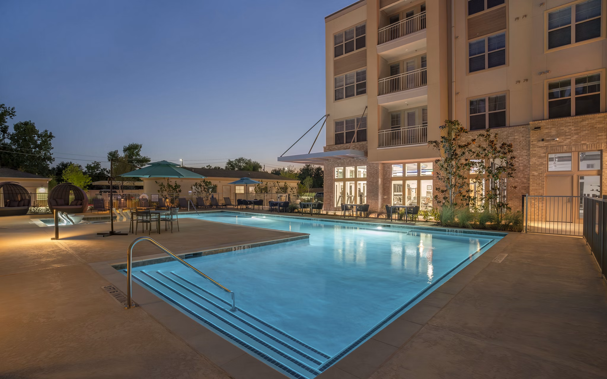 Modern pool with sun loungers at Jovie Pflugerville Apartments offering luxury outdoor relaxation