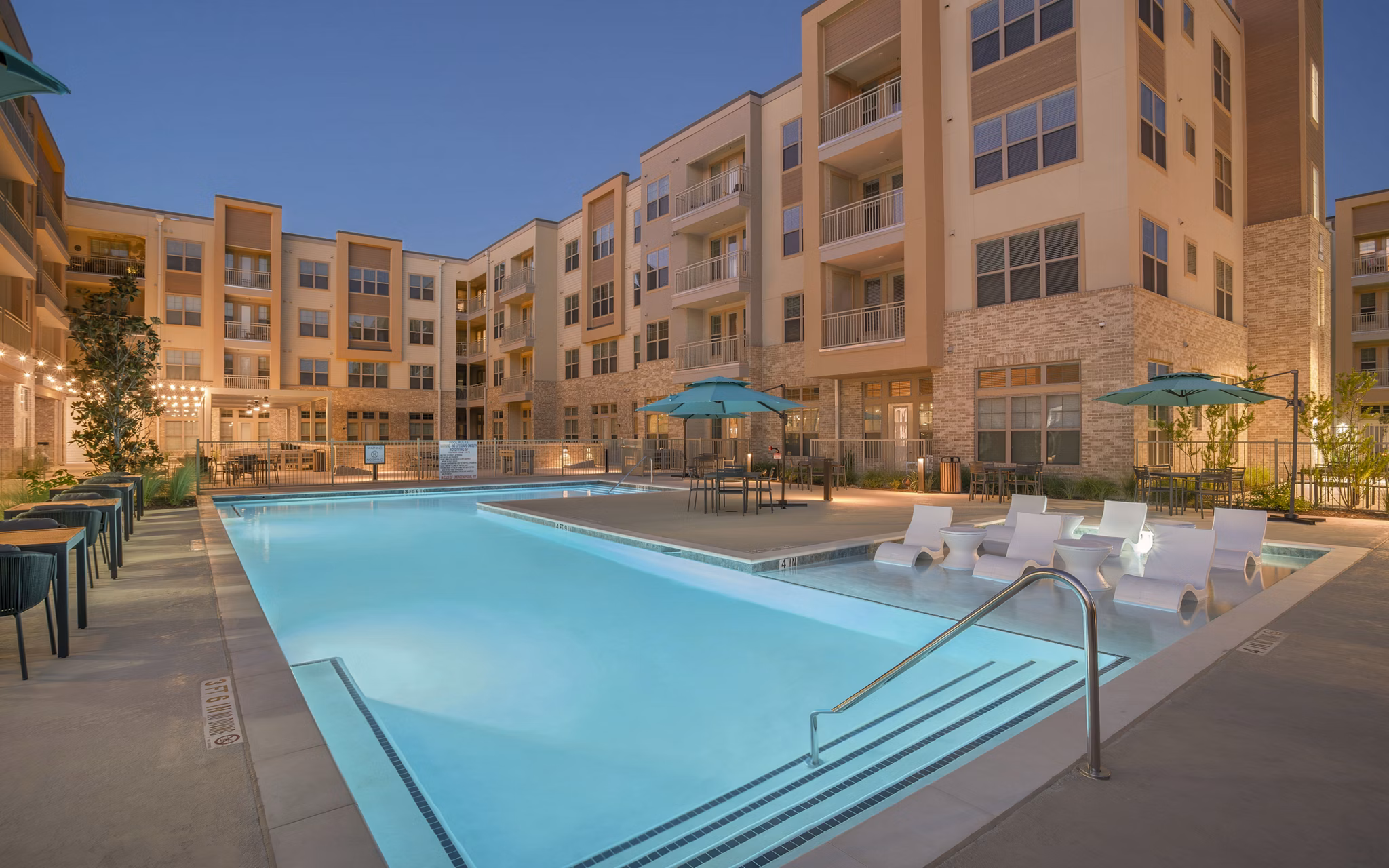Resort-style pool with loungers at Jovie Pflugerville Apartments