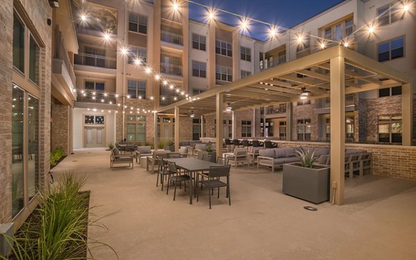 Jovie Pflugerville: Elegant courtyard with lush landscaping at luxury apartments