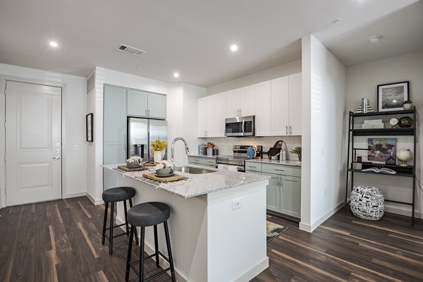 Modern kitchen with stainless steel appliances and sleek countertops at Prose Greenbriar Apartments, a Greystar luxury apartment community