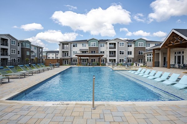 Sparkling pool with lounge chairs at Prose Greenbriar Apartments