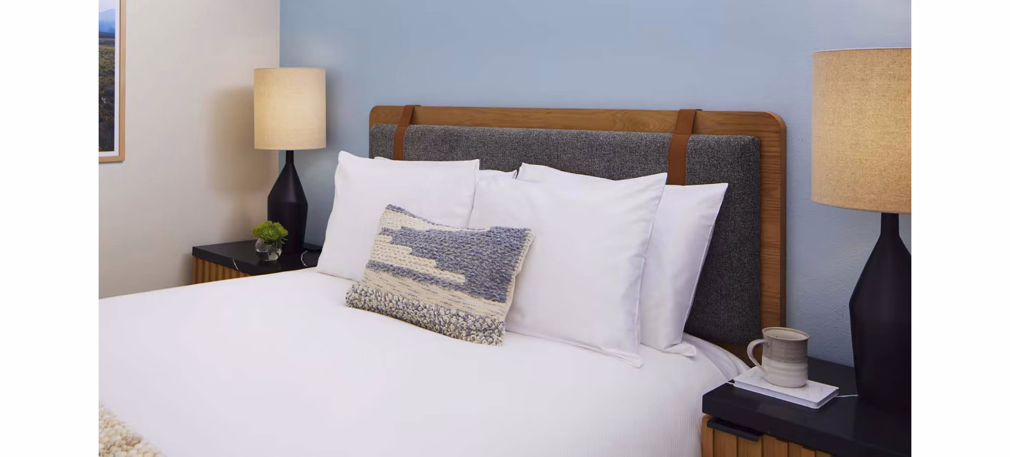 Cozy bedroom featuring modern decor and large windows in CHROMA Apartments