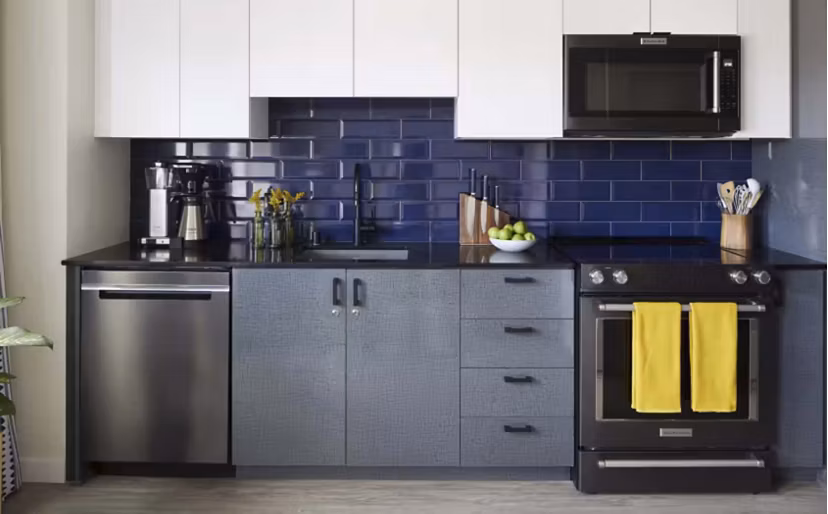 Modern kitchen with stainless steel appliances at CHROMA Apartments, offering sleek design and functionality for luxury living