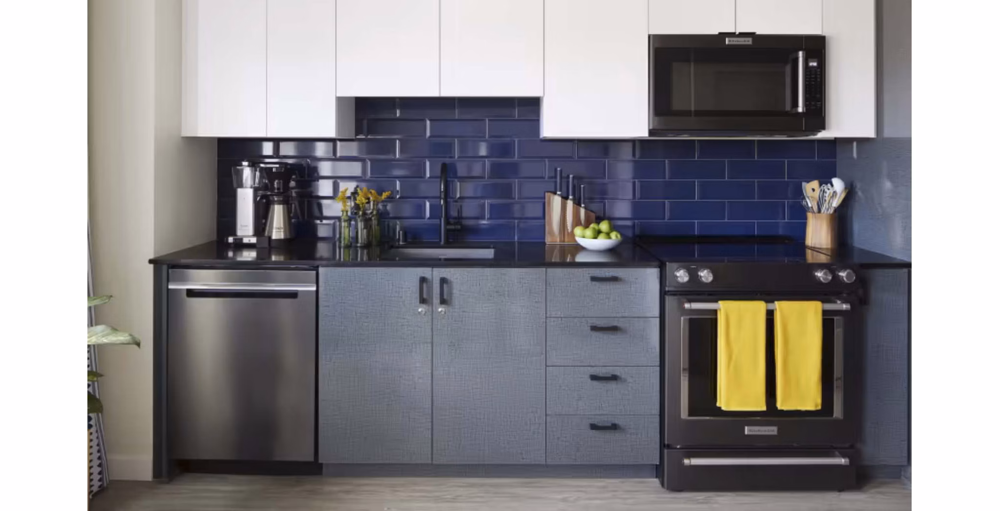 Modern kitchen with stainless steel appliances at CHROMA Apartments, offering sleek design and functionality for luxury living