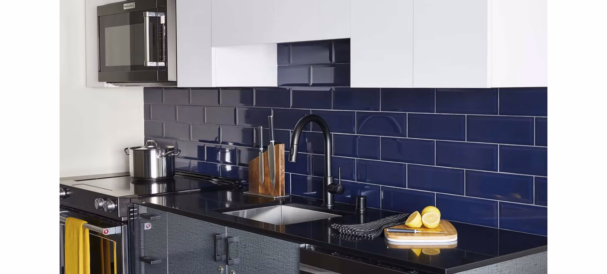 Modern kitchen with stainless steel appliances in CHROMA Apartments