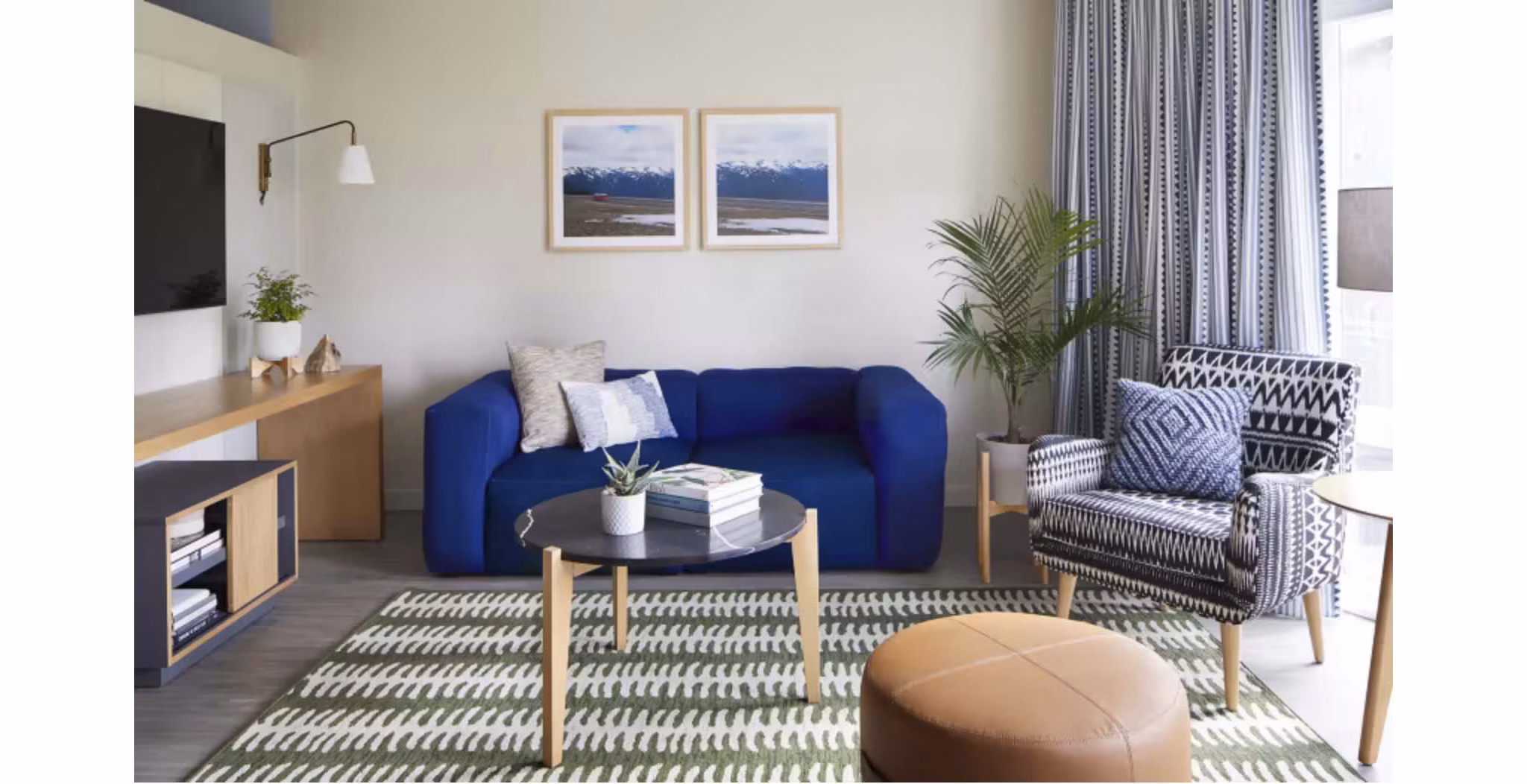 Spacious living room with modern decor in CHROMA Apartments, featuring comfortable seating and natural light for luxury urban living