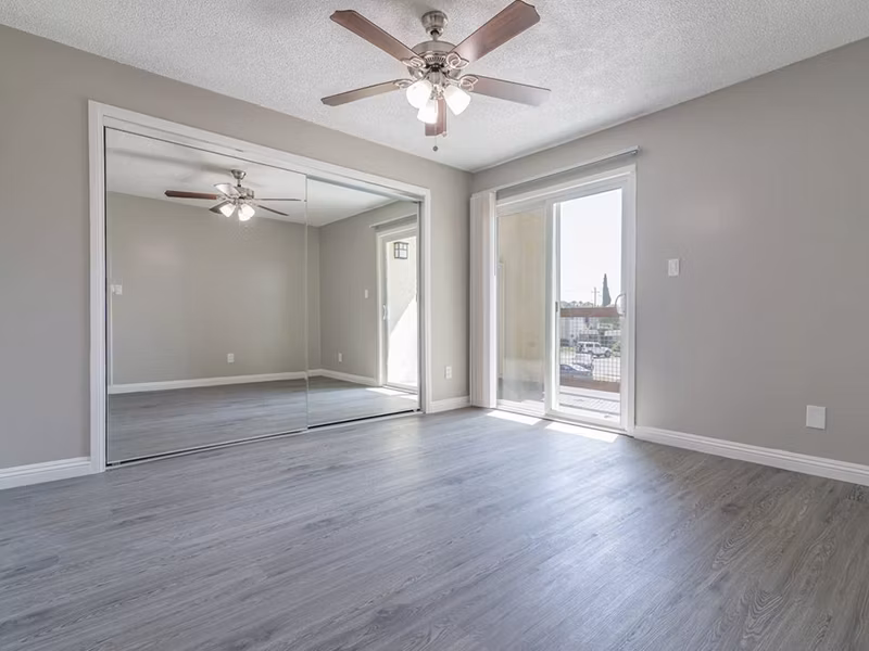 Cozy bedroom with modern decor and ample natural light at Citrus Court Apartments