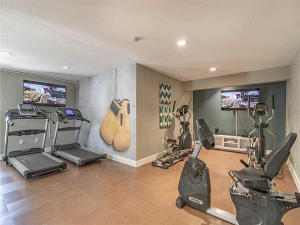 Fitness center with weight machines and yoga mats at Citrus Court Apartments