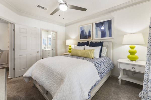 Cozy bedroom with elegant decor and large windows at Gramercy at Buckhead Apartments