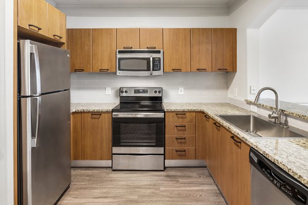 Modern kitchen with stainless steel appliances at Gramercy at Buckhead Apartments in Atlanta, GA