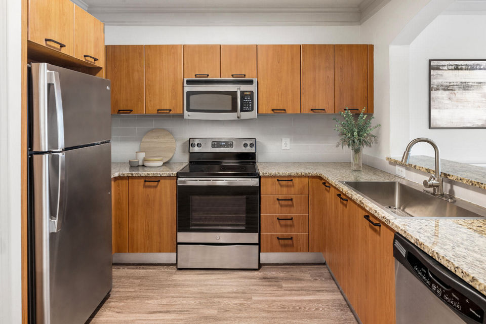 Modern kitchen with stainless steel appliances at Gramercy at Buckhead Apartments, offering luxury living in Atlanta