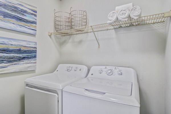 Laundry room with modern machines at Morgan Place Apartments in the Greystar property portfolio