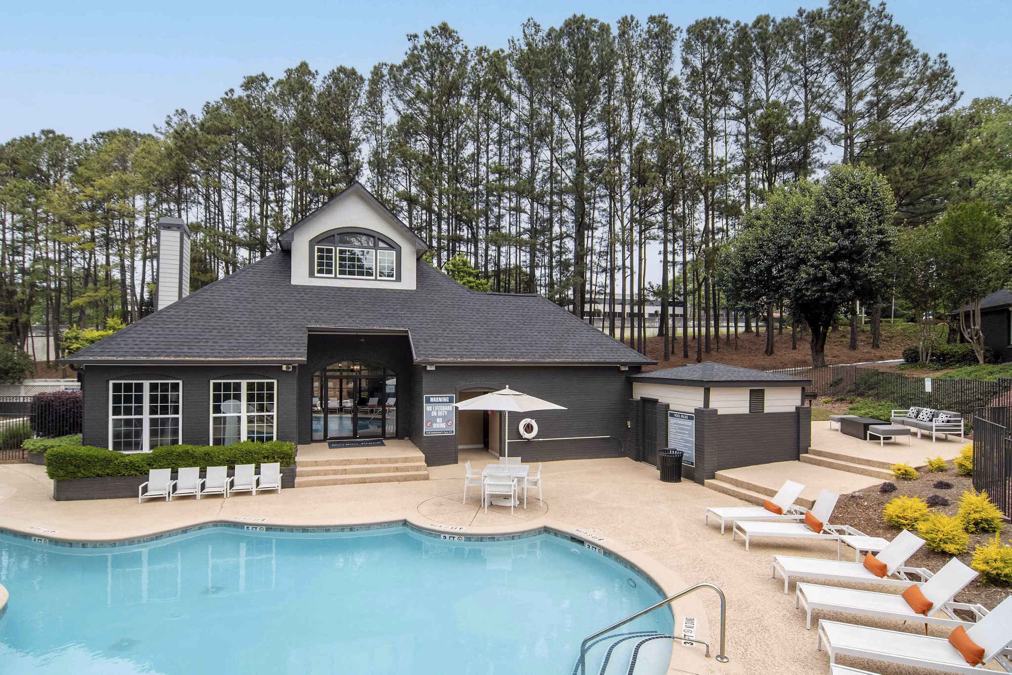 Resort-style pool with lounge chairs at Morgan Place Apartments, offering a luxury outdoor experience for relaxation and recreation