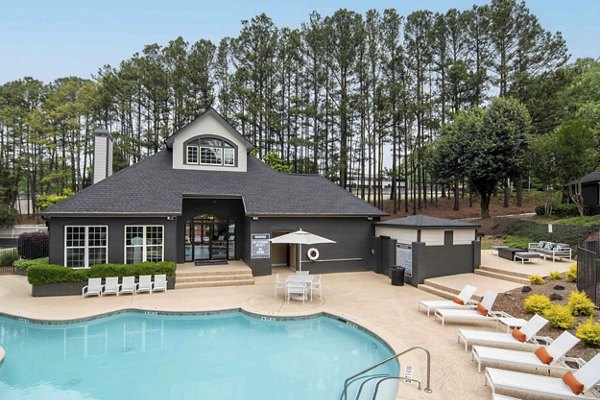 Resort-style pool with lounge chairs at Morgan Place Apartments, offering a luxury outdoor experience for relaxation and recreation
