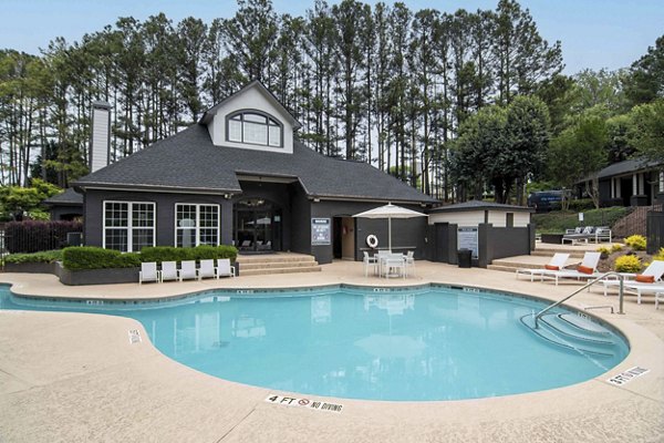 Resort-style pool area at Morgan Place Apartments with luxury loungers and lush landscaping