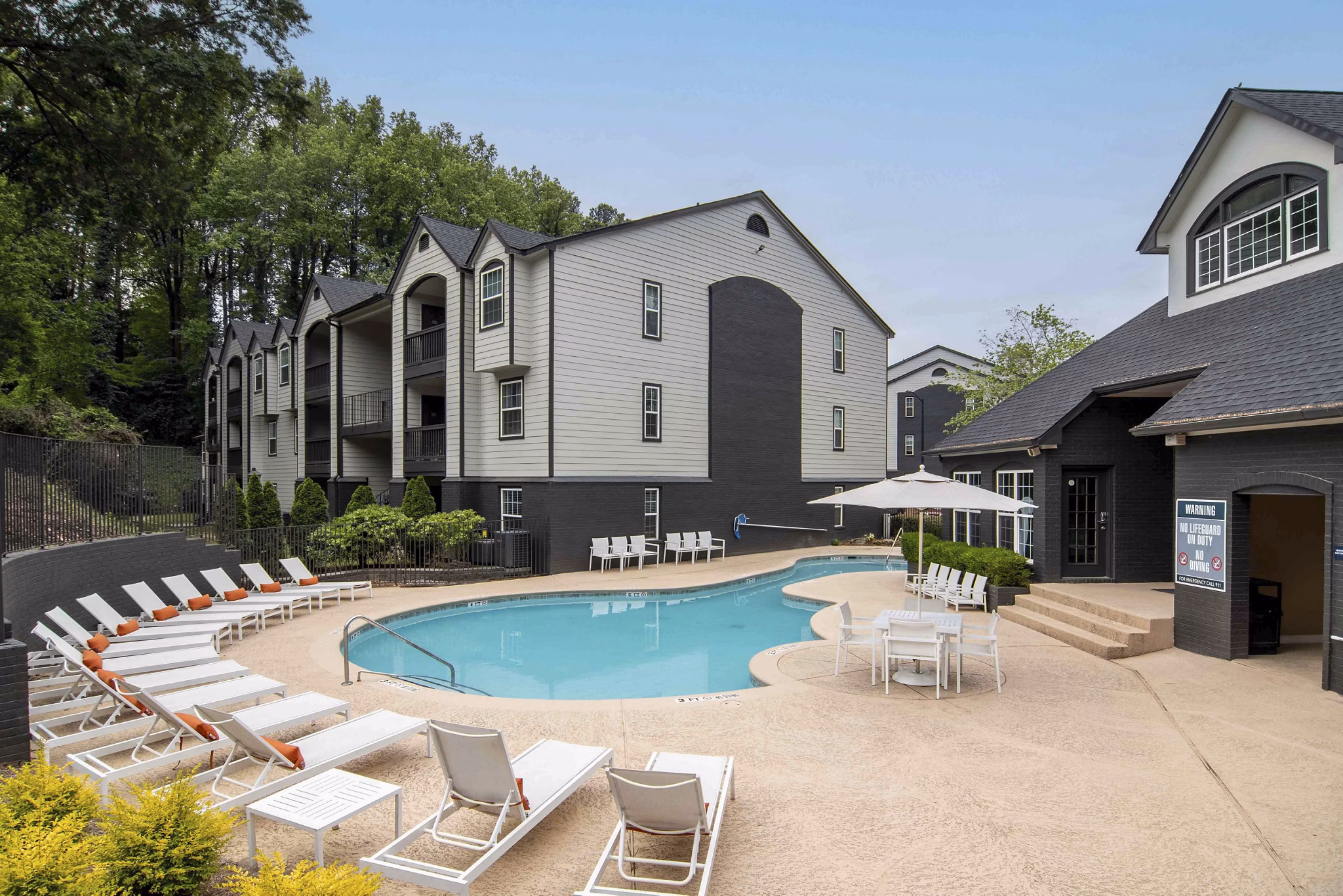Outdoor pool surrounded by lush landscaping at Morgan Place Apartments