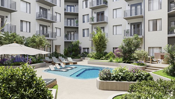 Inviting pool with seating area at The Bouldin Apartments, perfect for relaxation and leisure activities