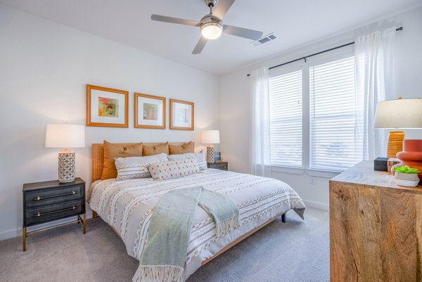 Spacious bedroom with elegant design at Napa Oaks Apartments, featuring luxurious furnishings and abundant natural light