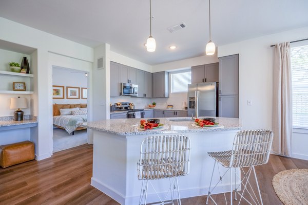 Modern kitchen with stainless steel appliances and granite countertops at Napa Oaks Apartments luxury living in scenic surroundings