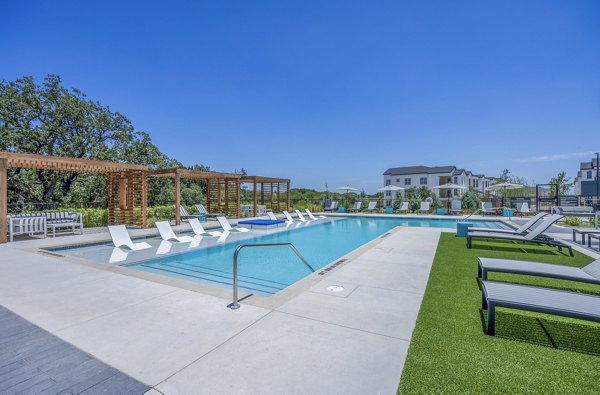 Resort-style pool with sun loungers at Napa Oaks Apartments, offering luxury living in a serene setting