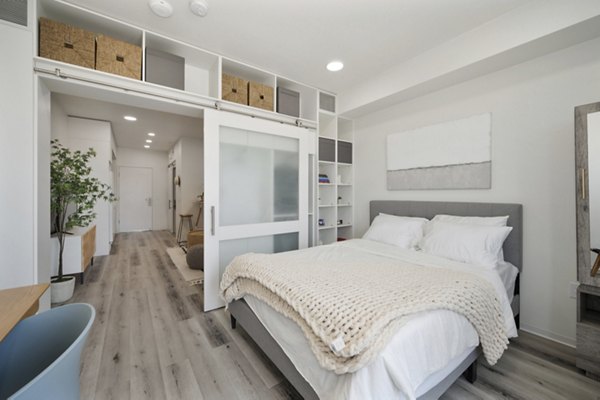 Modern bedroom with plush bedding and elegant decor at 3167 Market Apartments