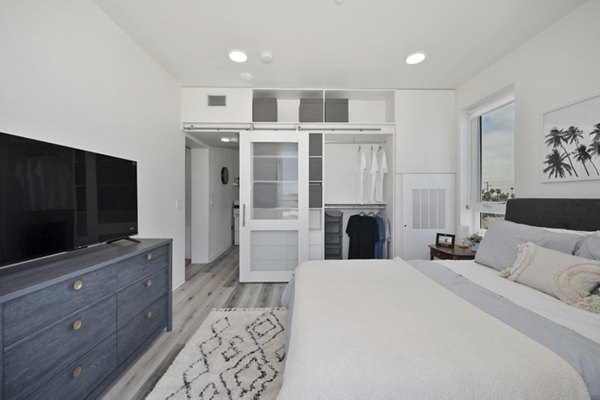 Bedroom featuring contemporary decor and plush bedding at 3167 Market Apartments