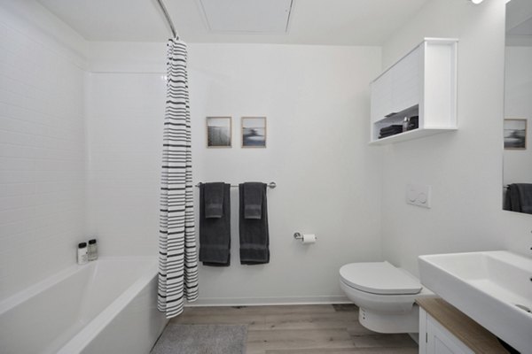 Bathroom featuring modern fixtures and marble countertops at 3167 Market Apartments