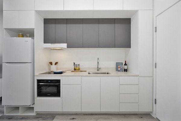 Modern kitchen with stainless steel appliances at 3167 Market Apartments