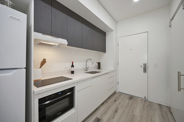 Modern kitchen with stainless steel appliances at 3167 Market Apartments