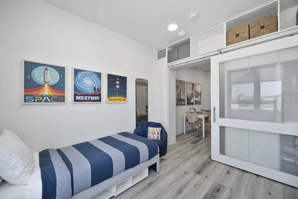 Spacious living room with natural light and modern furnishings at 3167 Market Apartments