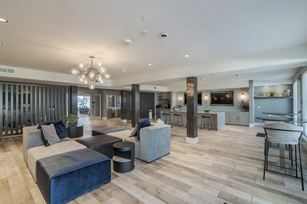 Clubhouse featuring modern design and luxe seating at The District in Little Elm Apartments