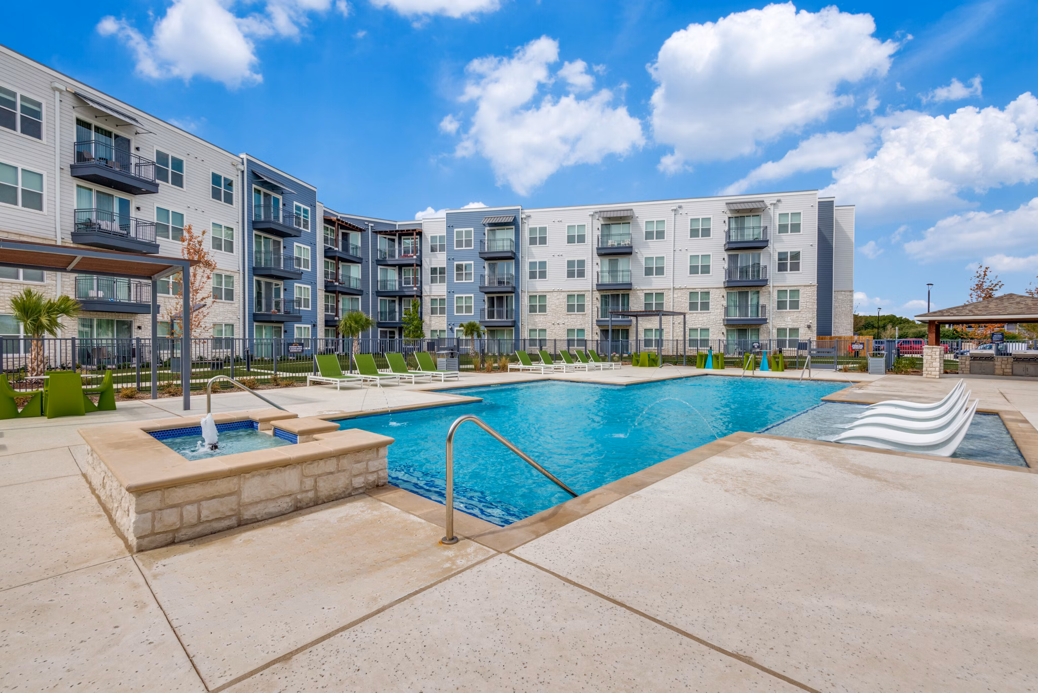 Resort-style pool at The District in Little Elm Apartments offering a luxurious swimming experience