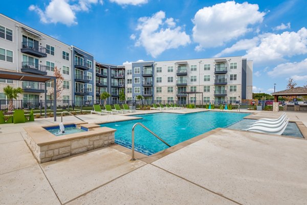 Resort-style pool at The District in Little Elm Apartments offering a luxurious swimming experience