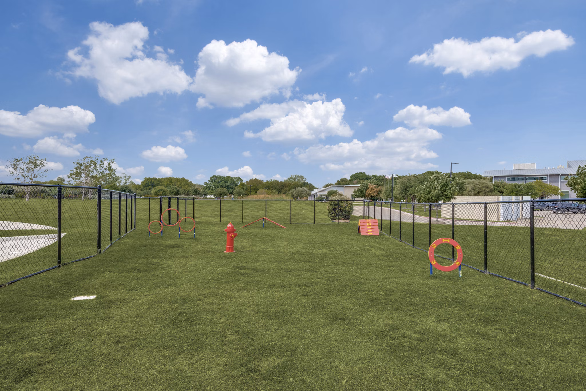 Dog park with agility equipment at The District in Little Elm Apartments