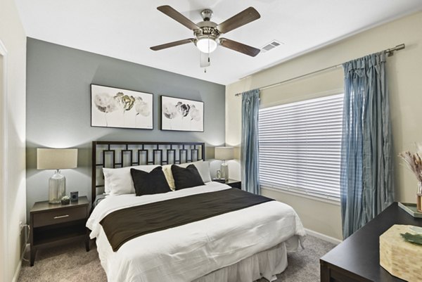 Cozy bedroom with modern furnishings at Agora Stone Oak Apartments