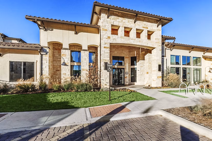 Stylish clubhouse with modern furnishings at Agora Stone Oak Apartments ideal for residents' gatherings and relaxation opportunities