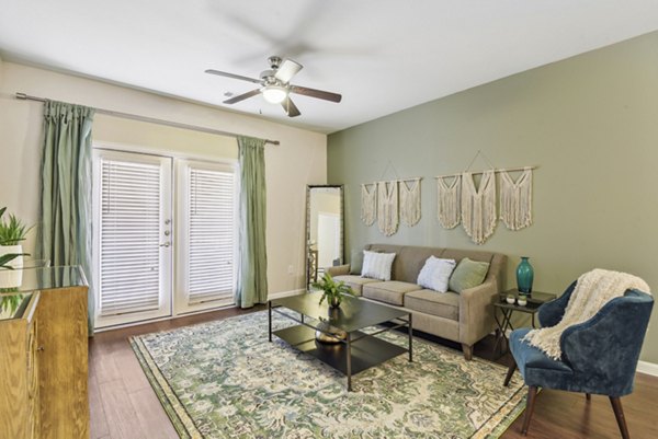 Spacious living room with stylish decor at Agora Stone Oak Apartments
