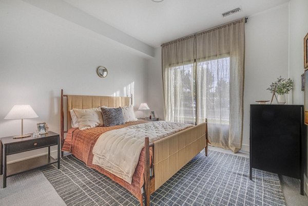 Bedroom featuring elegant design and modern furnishings at The Opal Apartments