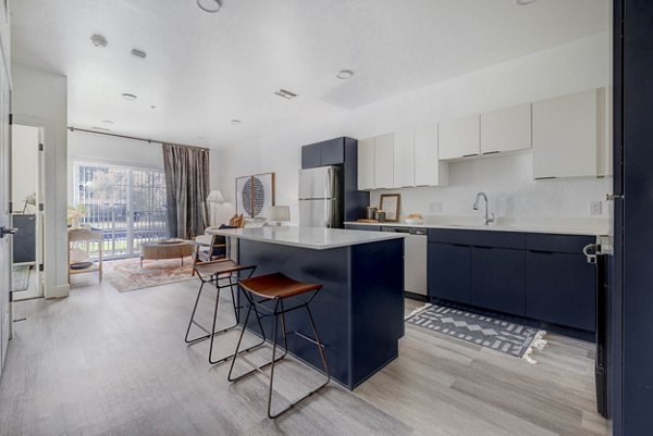 Modern kitchen with sleek cabinetry and stainless steel appliances at The Opal Apartments