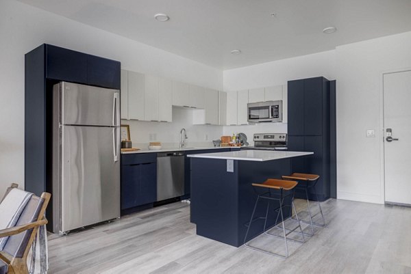 Modern kitchen with stainless steel appliances at The Opal Apartments