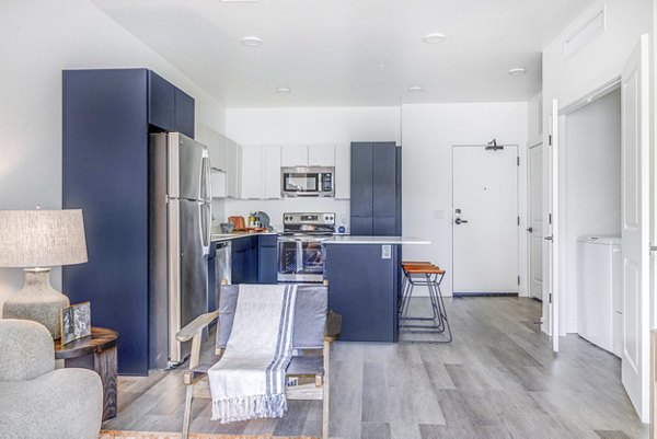 Modern kitchen with sleek cabinetry and stainless steel appliances at The Opal Apartments