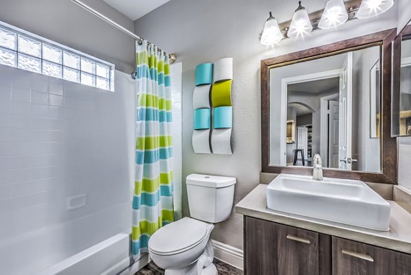 Bathroom featuring sleek fixtures and tiled flooring at Parkway Townhomes