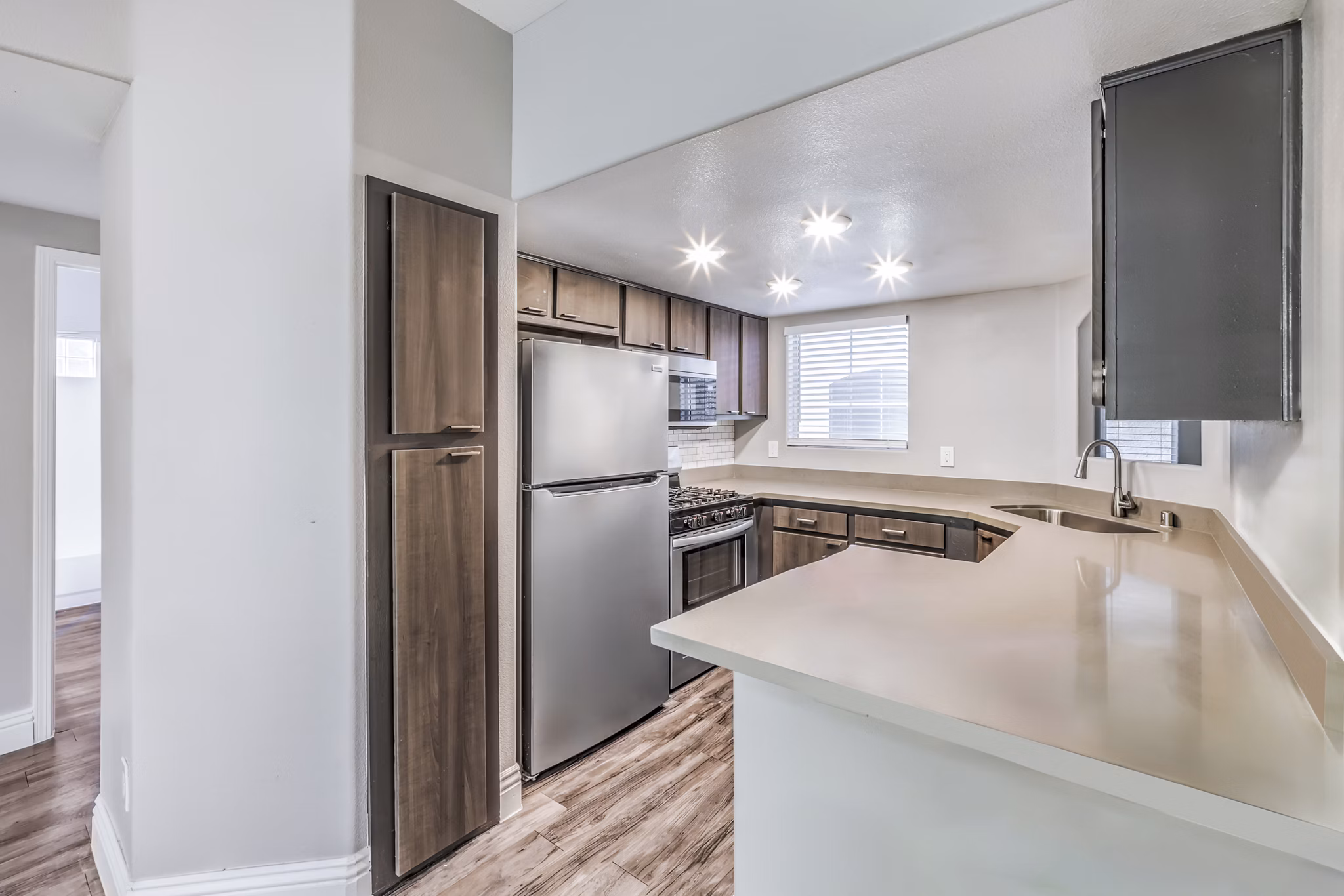 Modern kitchen with stainless steel appliances in Parkway Townhomes
