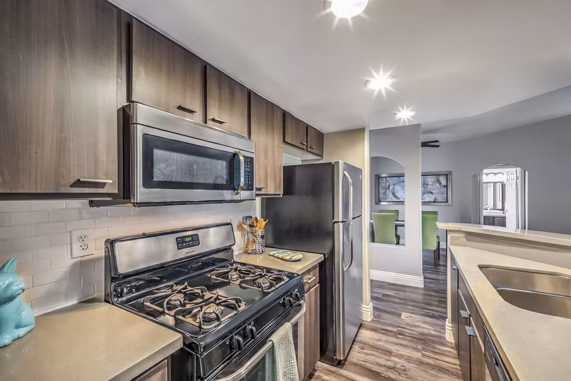 Modern kitchen featuring stainless steel appliances in Parkway Townhomes