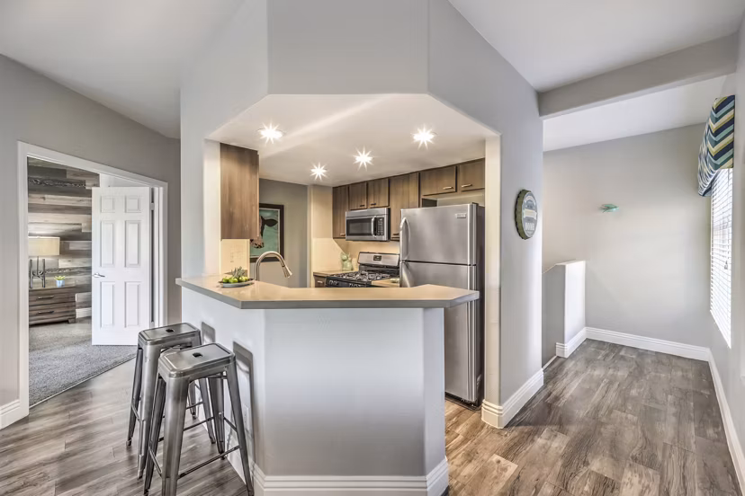 Modern kitchen with stainless steel appliances in Parkway Townhomes