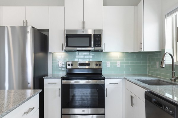 Modern kitchen with stainless steel appliances at Lighthouse Pointe Apartments, a luxury Greystar community