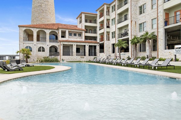 Resort-style pool with lounging area at Lighthouse Pointe Apartments