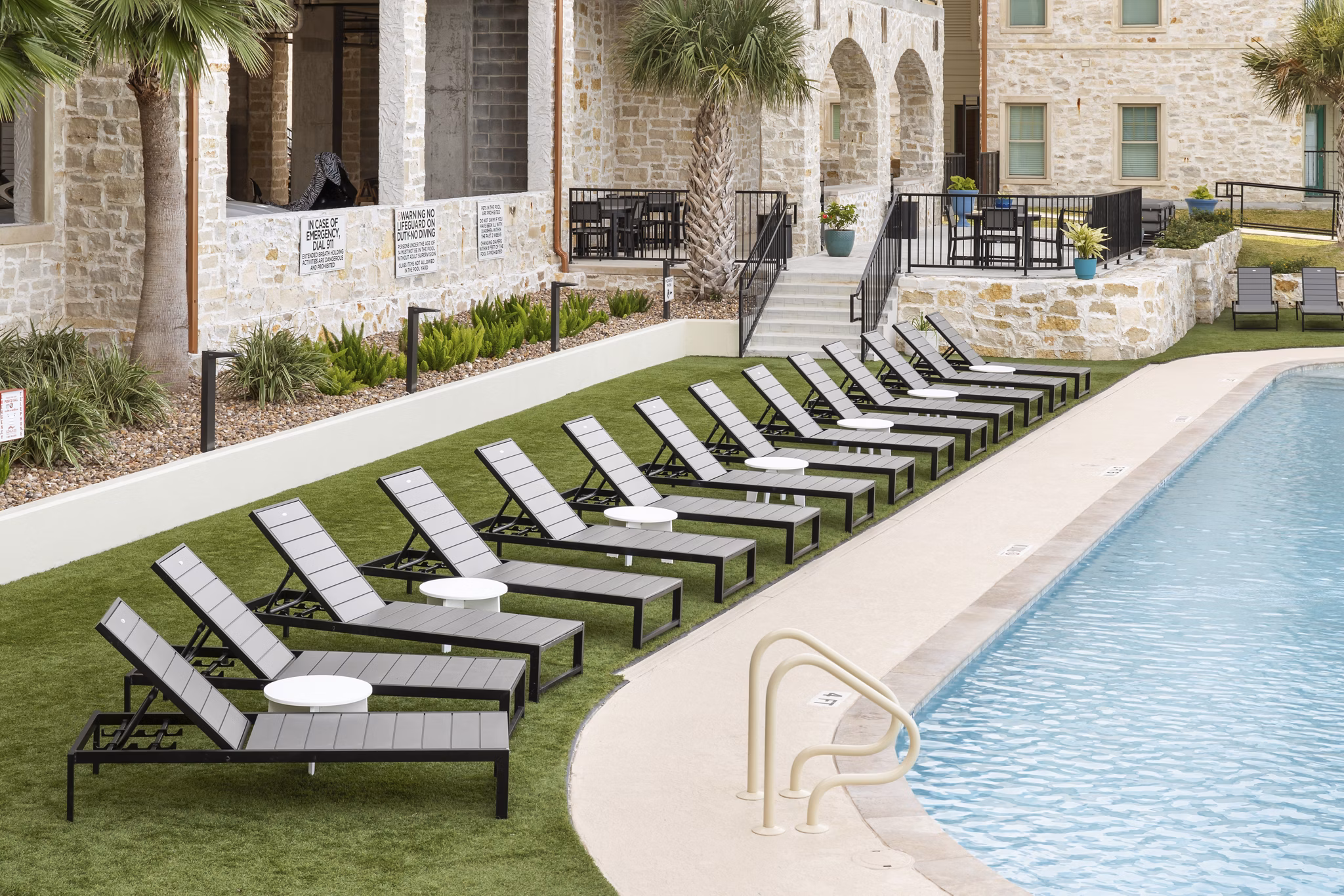 Resort-style pool with cabanas at Lighthouse Pointe Apartments offering luxury beachfront living