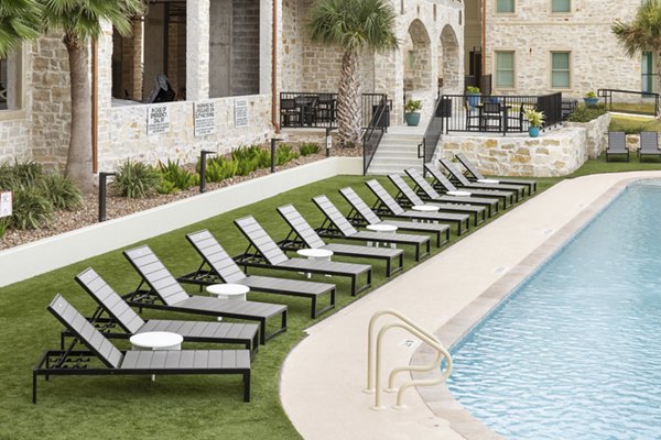 Resort-style pool with cabanas at Lighthouse Pointe Apartments offering luxury beachfront living